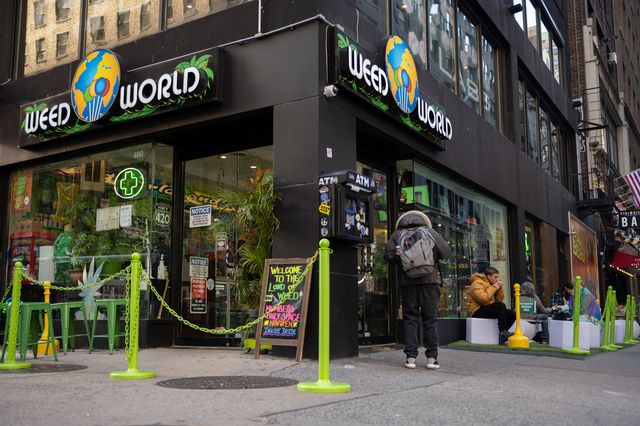 People sit in a "smoking section" outside Weed World on November 16, 2021 in New York City.